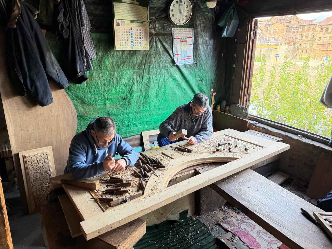 Artisans shaping traditional Kashmiri woodwork by hand